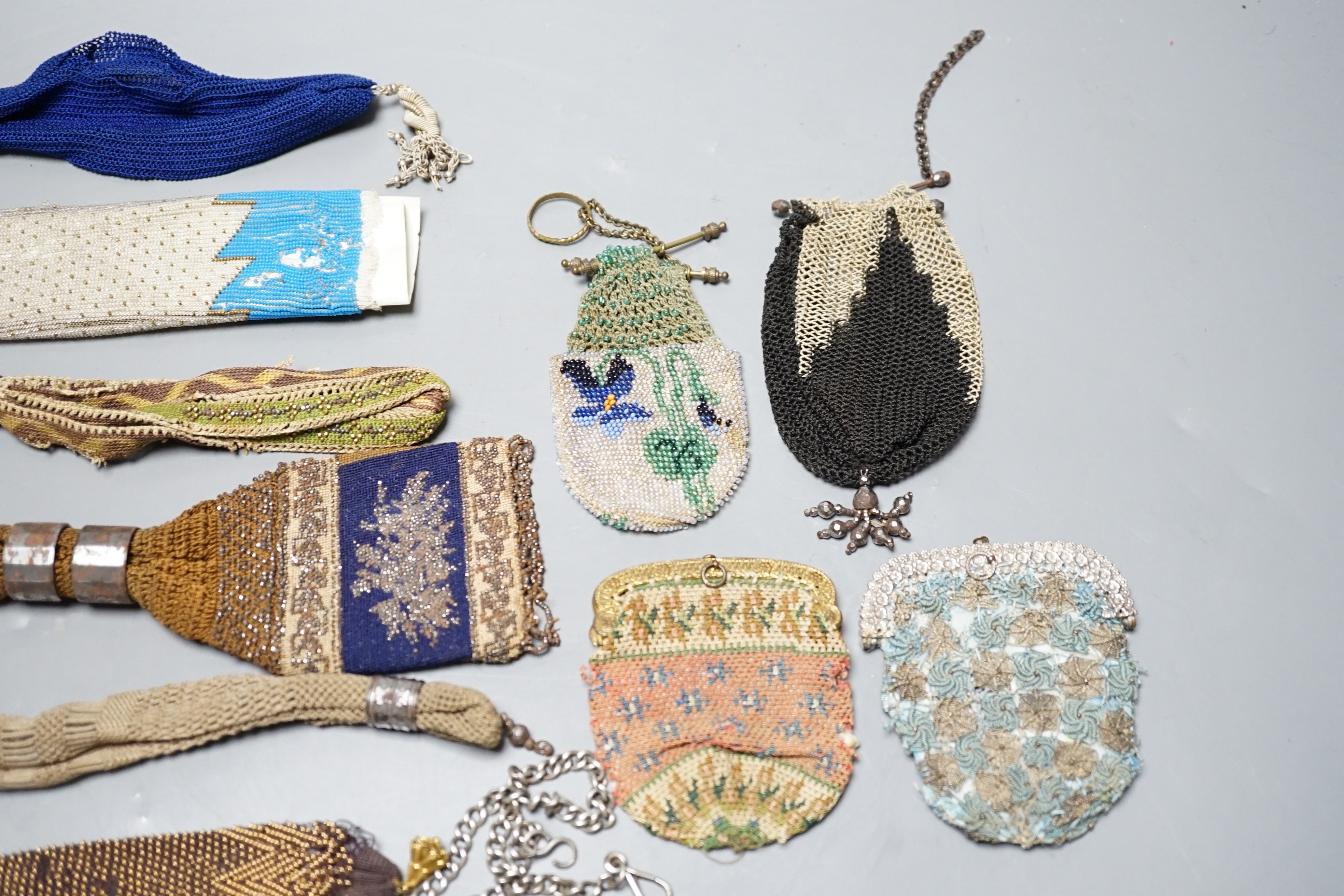 Seven 19th century cut steel misers purses, five beaded and knitted metal framed purses, two reticules, two novelty knitted jug shaped purses and two others